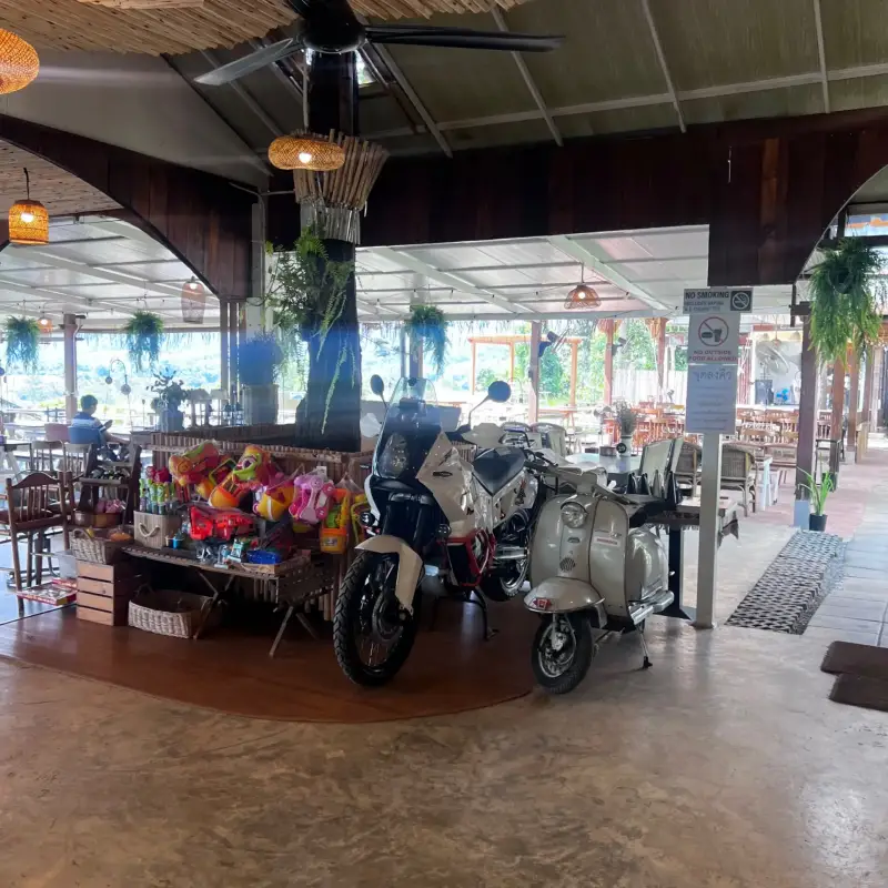 Two scooters displayed among seating and merchandise