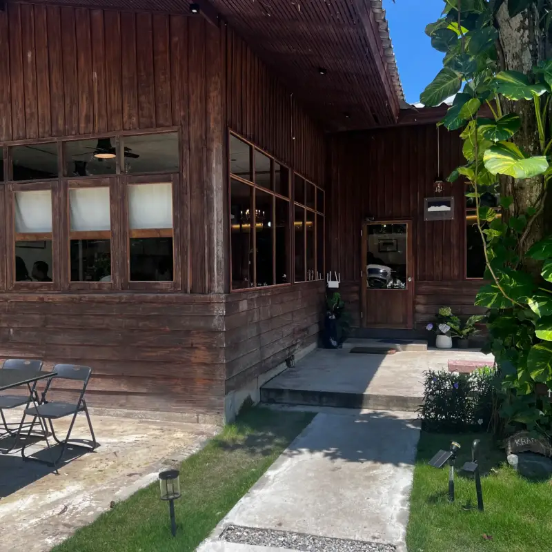 Entrance steps and wooden windows along the side of the building